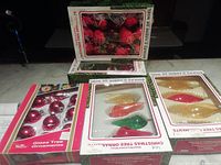 Overview of five boxed ornament sets
