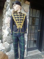 Mannequin front view wearing navy braid jacket, Gordon trews, beret cap