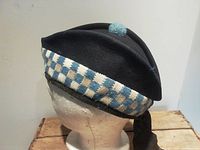Side view of WWII Toronto Scottish Regiment glengarry cap showing diced band and toorie