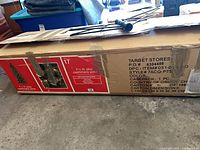 Full view of boxed artificial Christmas tree showing product graphics and taped box