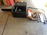 Chainsaw in case with blade, soldering iron box, saw frames