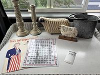 All seven items grouped on tray: candlesticks, sheep figures, pail, sheet music, chord chart
