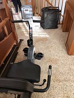 Front view showing display console, handlebars, pedals, overall structure