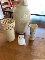Three Lenox ivory porcelain vases grouped on table