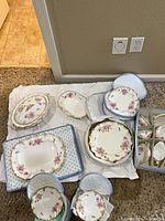 Group of platters, plates, serving pieces with padded dividers