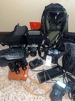Group shot of all cameras, bags, flash and binoculars