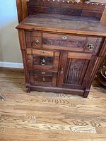 Front view of washstand showing drawers, door, backsplash, hardware