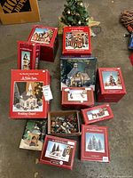 Group view of nine red boxes, tabletop tree, and open figurine box