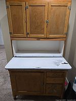 Full view of Hoosier cabinet showing upper and lower sections and enamel work surface
