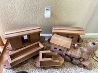 Full set of wooden train pieces on carpet