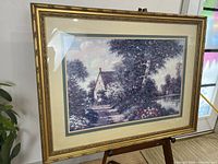 Full view of framed artwork on easel