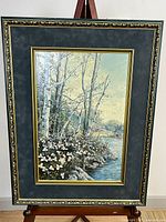 Full view of framed artwork on easel