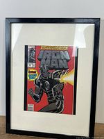 Front view of framed Iron Man comic in black frame