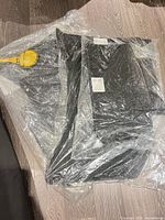 Sealed black carpet floor mats in clear plastic