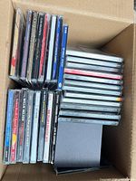 Open box showing majority of CD jewel cases stacked