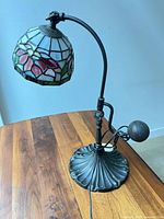 Full view of lamp showing base, arm, counterweight, and shade