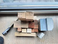 stacked wood blocks, soapstone pieces and saw overview