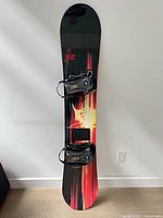 Full view of K2 snowboard with bindings attached