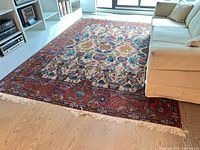 Rug fully laid out showing size, border, field pattern and fringe