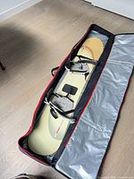 Snowboard with bindings inside open carry bag