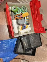 Overview of tote with tapes, rollers, sandpaper, adhesive, filler