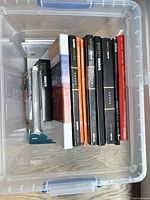 Top view of plastic bin showing multiple boxed photo paper packs