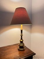 Full view of lamp on table showing base and shade
