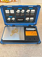 Necklace on digital scale showing 1.56 g