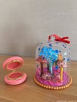 Cloche ornament beside open macaron trinket box showing interior and scale