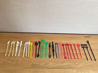 Full lineup of 29 plastic swizzle sticks showing colours and variety