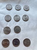 All 11 coins reverse side designs visible