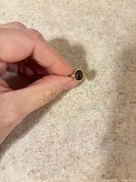 Top view of gold vermeil ring with oval amethyst cabochon