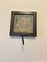 Front view of framed textile wall hook