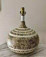 Front view of ceramic lamp base showing overall shape and glaze