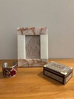 Overview of all three items: stone frame, inlaid box, cuff bracelet