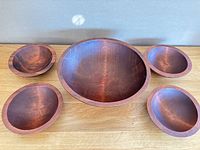 Full set of five wooden bowls displayed, showing sizes