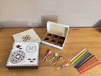 Overview of all items: boxed teak napkin rings, boxed sandwich mats, loose swizzle sticks and cocktail picks