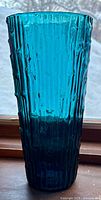 Full view of teal Empoli vase showing texture and color