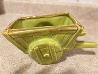 Left side view of green ceramic wheelbarrow planter