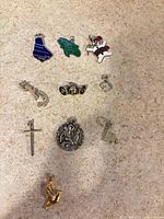 All ten charms laid out on surface