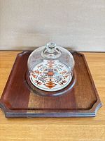Top view of teak board with ceramic tile and glass dome assembled