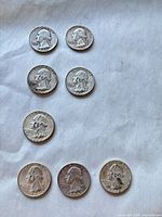 obverse faces of eight Washington quarters