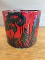 Side view showing red glaze and foliage motif