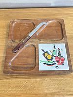 Full view of cheese board, knife and tile