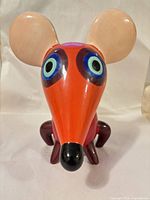 Front view of ceramic mouse bank showing eyes, nose and legs