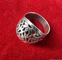 Side view of sterling silver ring showing openwork design and band