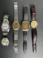 Group shot of six men’s wristwatches showing overall lot