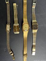 Four watches laid out side by side showing overall appearance