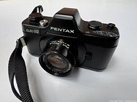 Front angled view showing body, lens, strap, model marking