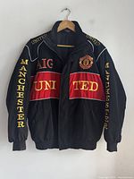 Front view of jacket showing chest band, lettering and crest